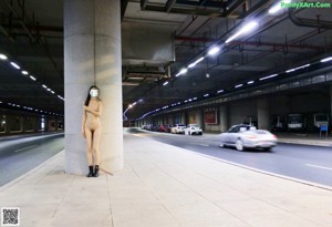 A naked woman wearing a face mask in a grocery store.