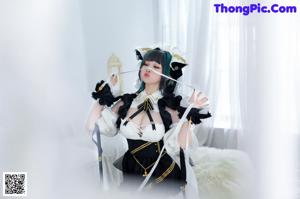 A woman in a maid outfit is posing for a picture.