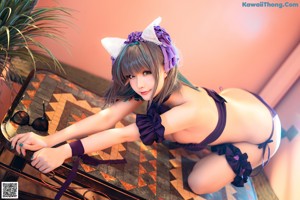 A woman in a purple and white outfit posing for a picture.