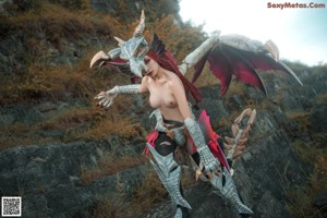 A woman with red hair wearing a dragon mask.