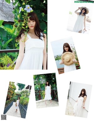 A woman in a white dress and straw hat posing for a picture.