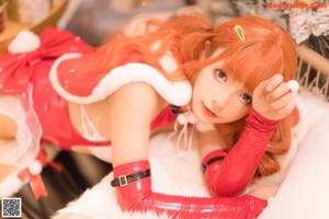 a woman in a santa claus outfit posing for a picture