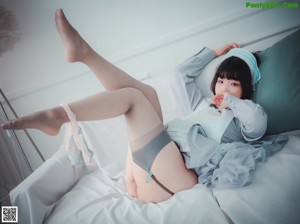 A woman in a nurse outfit is sitting on the floor.