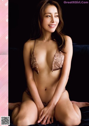 A magazine with a picture of a woman in a white dress.