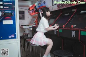 A woman in a bunny costume sitting on a table.