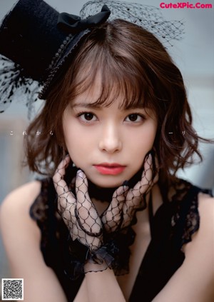 A woman in a black lingerie posing for a magazine cover.