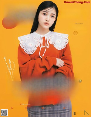 A woman in a kimono is posing for a magazine.