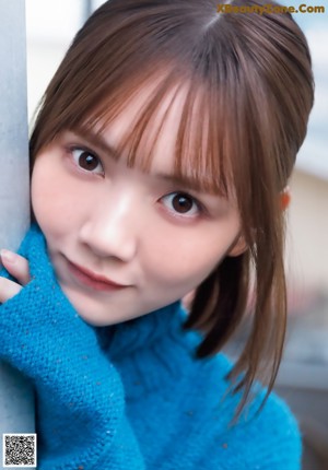 A close up of a person holding a yellow scarf.