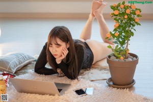 A woman laying on the floor with her legs crossed.